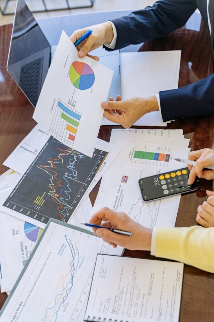 pexels-photo-5816283 Business professionals analyzing financial charts and graphs during a meeting.